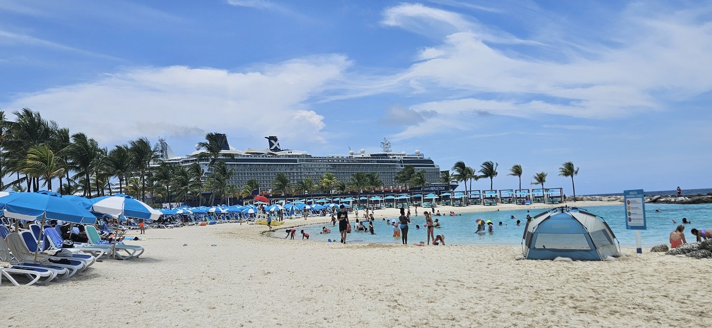 Celebrity Cruise ship at a private beach with palm trees