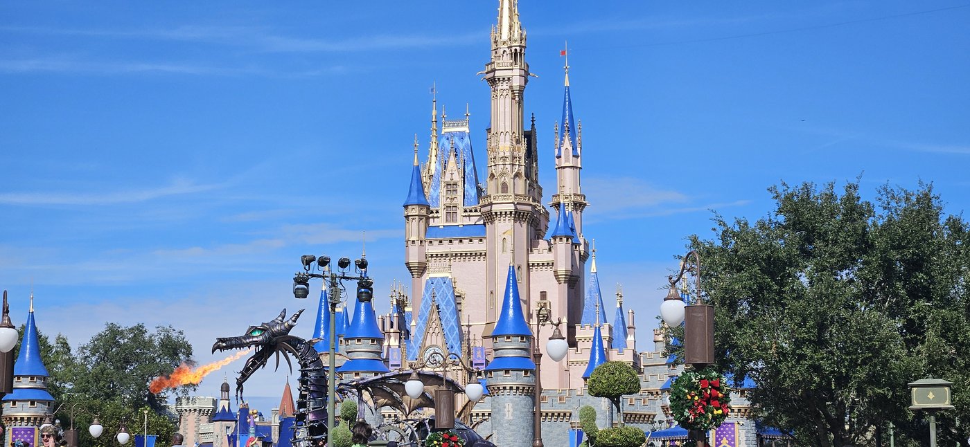 Cinderella Castle at Magic Kingdom with the Maleficent dragon float
