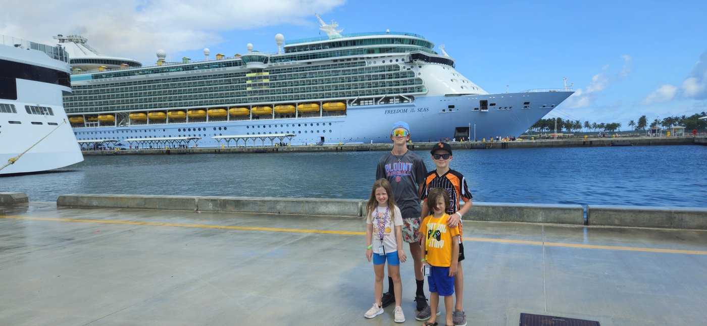 The Newman family in front of two Royal Caribbean ships